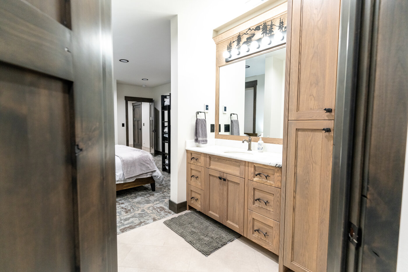 Beautiful Views — bathroom with bedroom view through the doorway and oak vanity