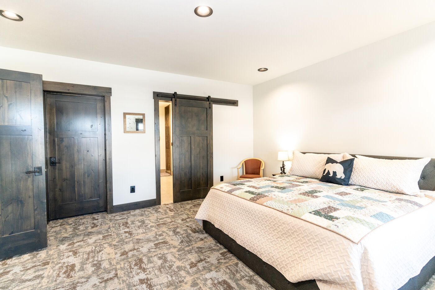 Beautiful Views — bedroom with king bed and barn-door bathroom entrance