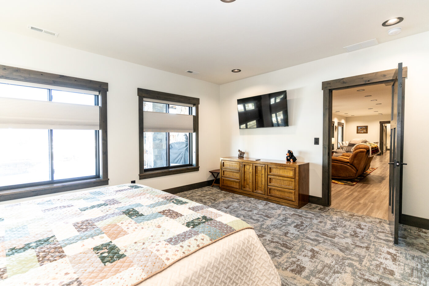 Beautiful Views — bedroom with quilted king, wall-mounted TV, and large window