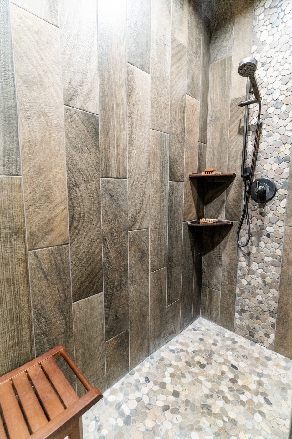 Beautiful Views — close-up of the wood-grain tile shower walls with rain head and bench
