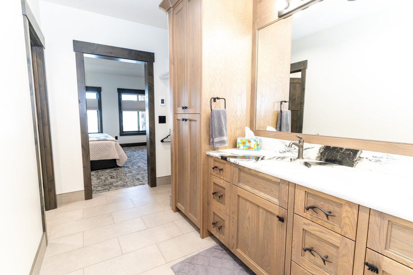 Beautiful Views — bathroom with white-marble vanity and bedroom visible through the open doorway