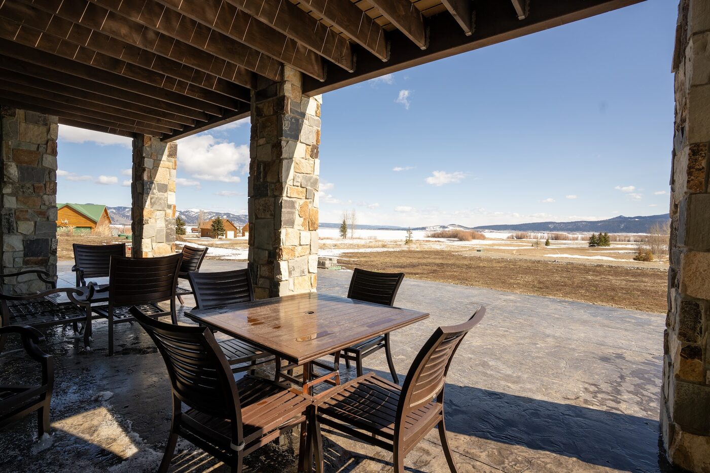 Beautiful Views — covered porch with outdoor dining facing Henry's Lake