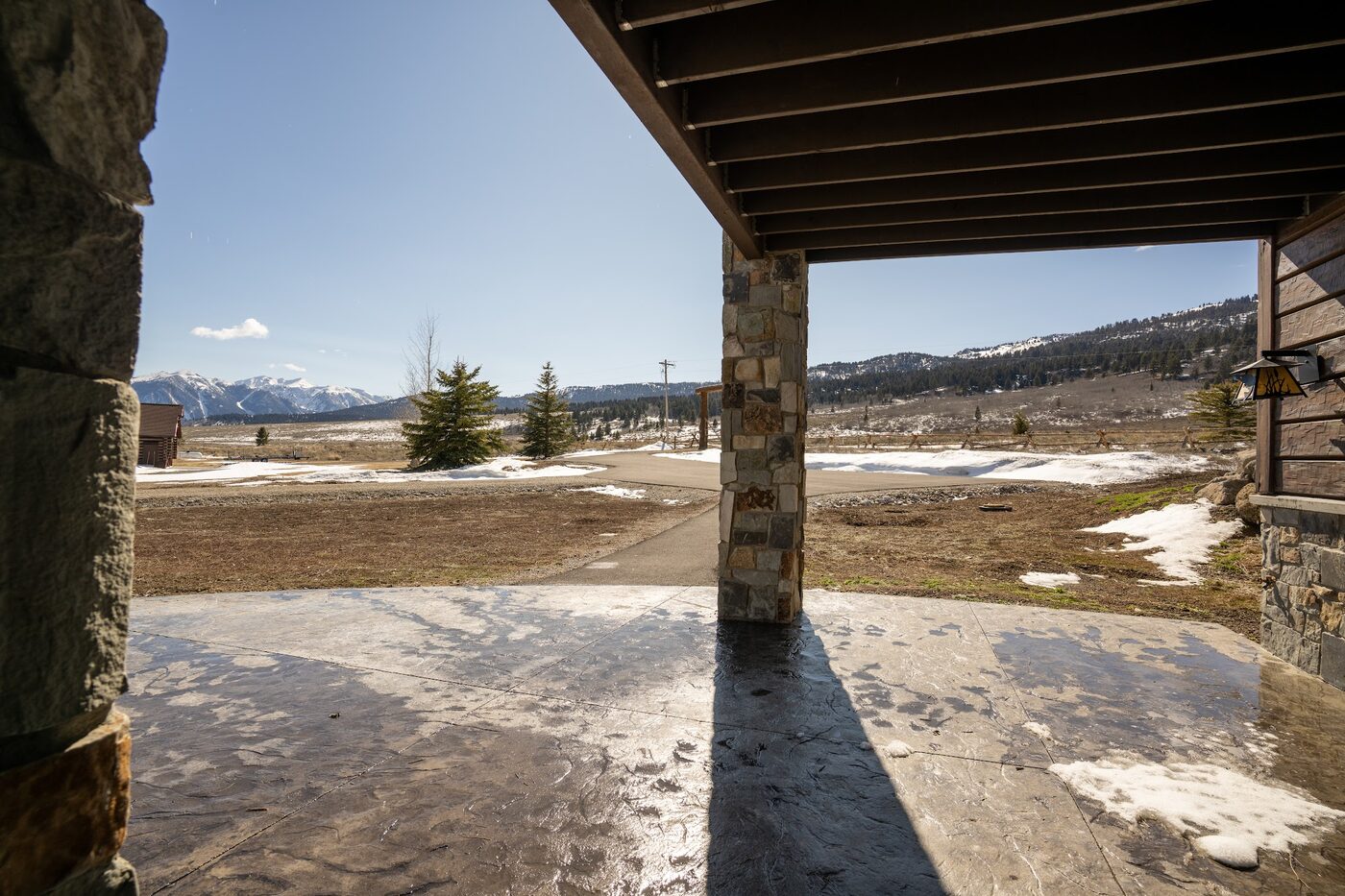 Beautiful Views — covered porch looking out across the snow-melt landscape toward Henry's Lake