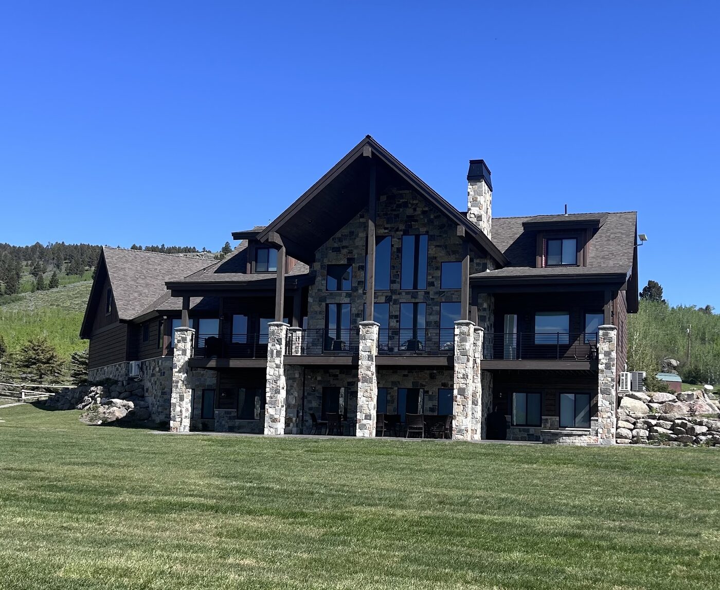 Beautiful Views — rear exterior from the lawn showing the multi-tier walkout architecture