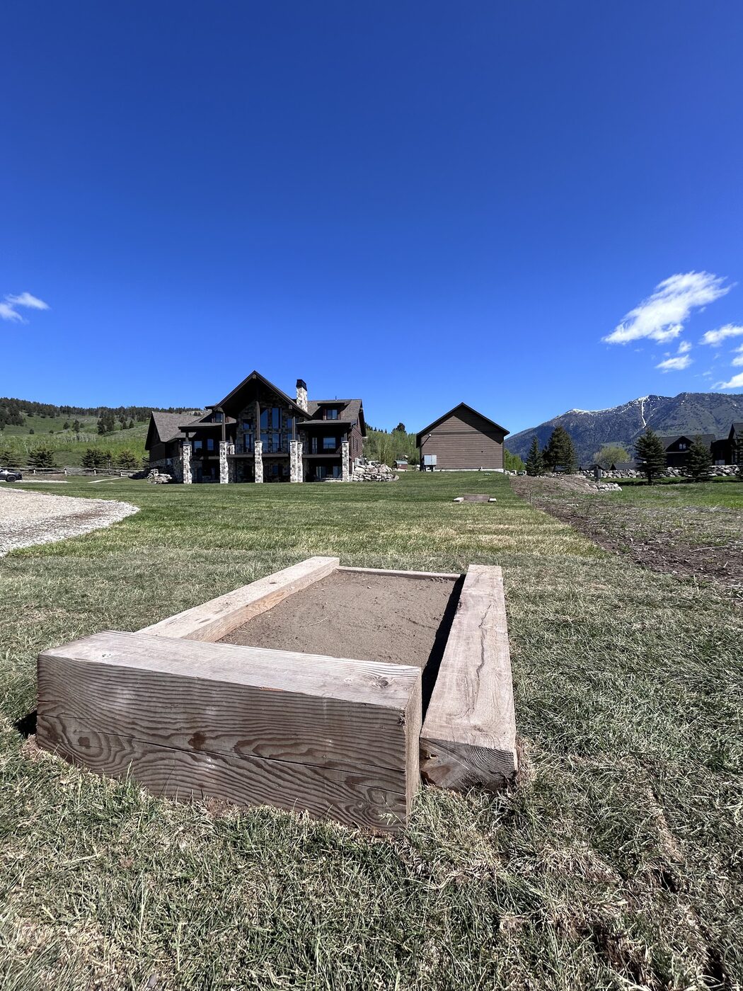 Beautiful Views — horseshoe pit on the lawn with the cabin in the background