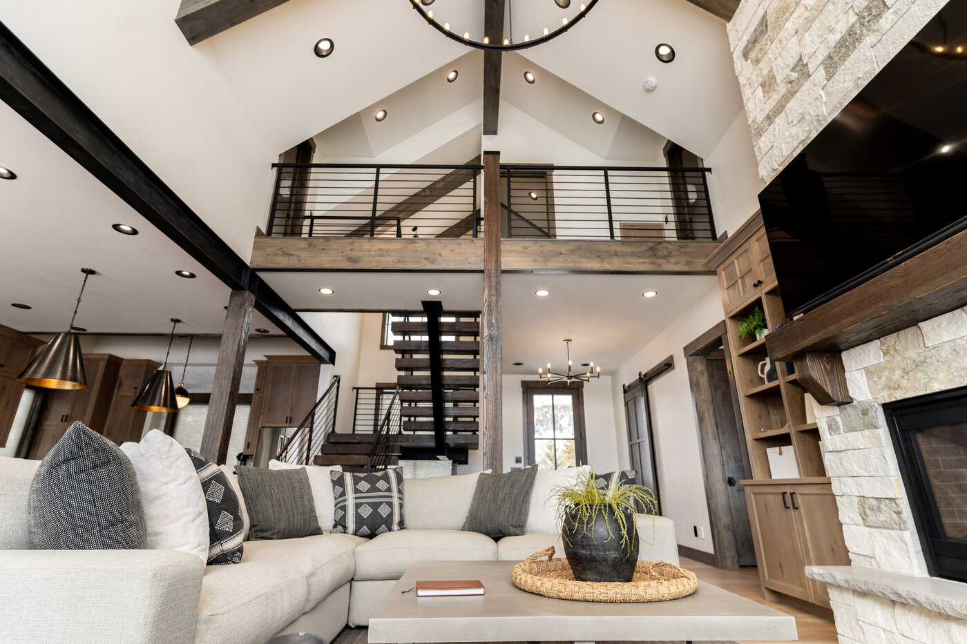 Lodge at Cutthroat Landing — great room with two-story cathedral ceiling, sectional, and stone fireplace