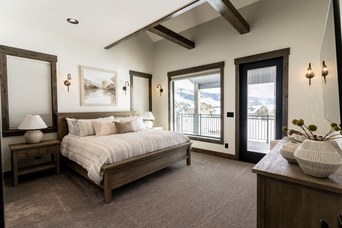 Lodge at Cutthroat Landing — primary bedroom with king bed and Centennial Range view through sliding doors