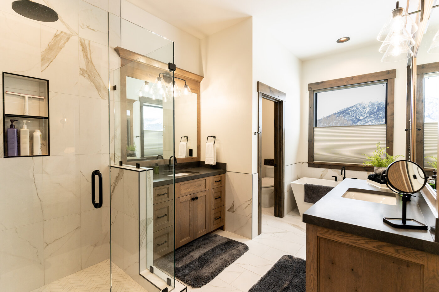 Lodge at Cutthroat Landing — primary en-suite with walk-in marble shower, dual vanity, and soaking tub