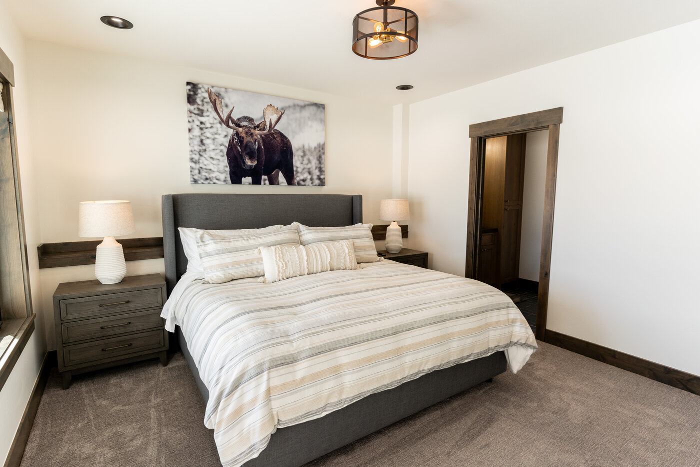 Lodge at Cutthroat Landing — king bedroom with framed moose photograph above the headboard
