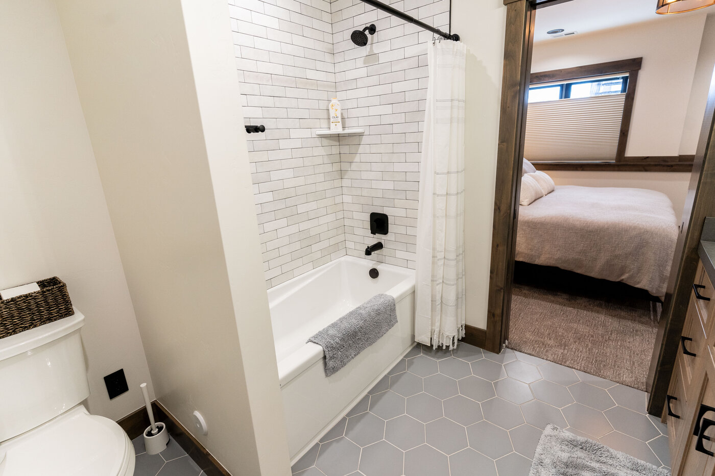 Lodge at Cutthroat Landing — secondary bathroom with subway tile, hexagon floor, and bedroom beyond