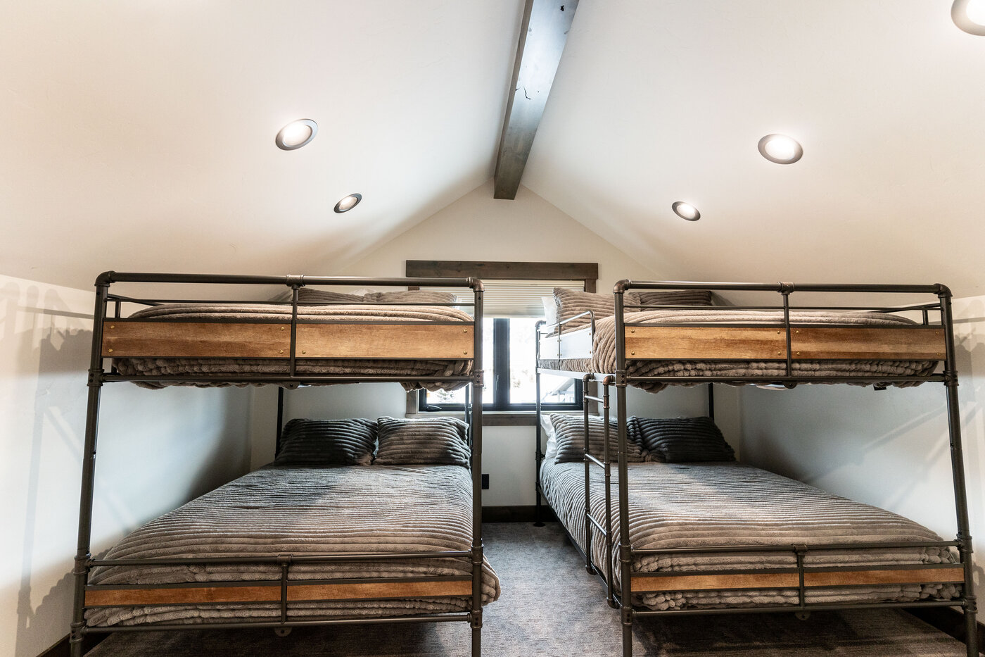 Lodge at Cutthroat Landing — bunk loft with four metal twin-over-twin bunks under vaulted ceiling