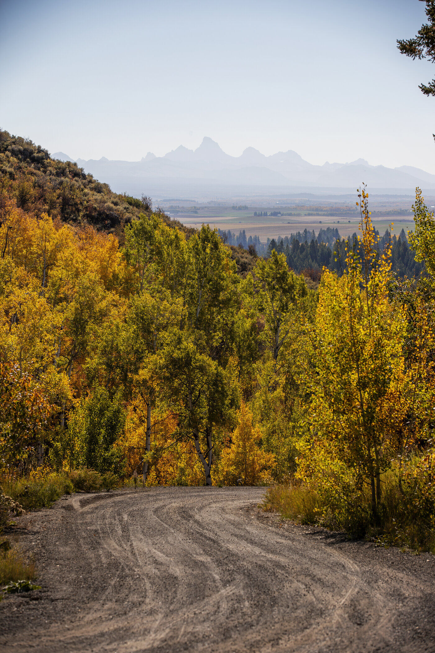 Teton View Retreat — Both Domes — dirt access road approaching the property with the Tetons in the distance