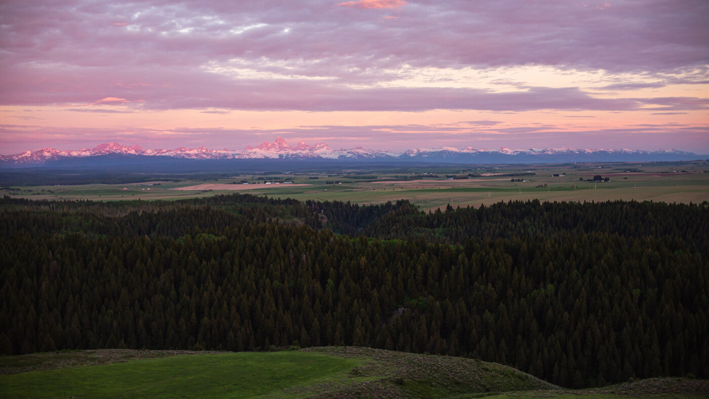 Teton View Retreat — Both Domes — panoramic Tetons at pink twilight from the property