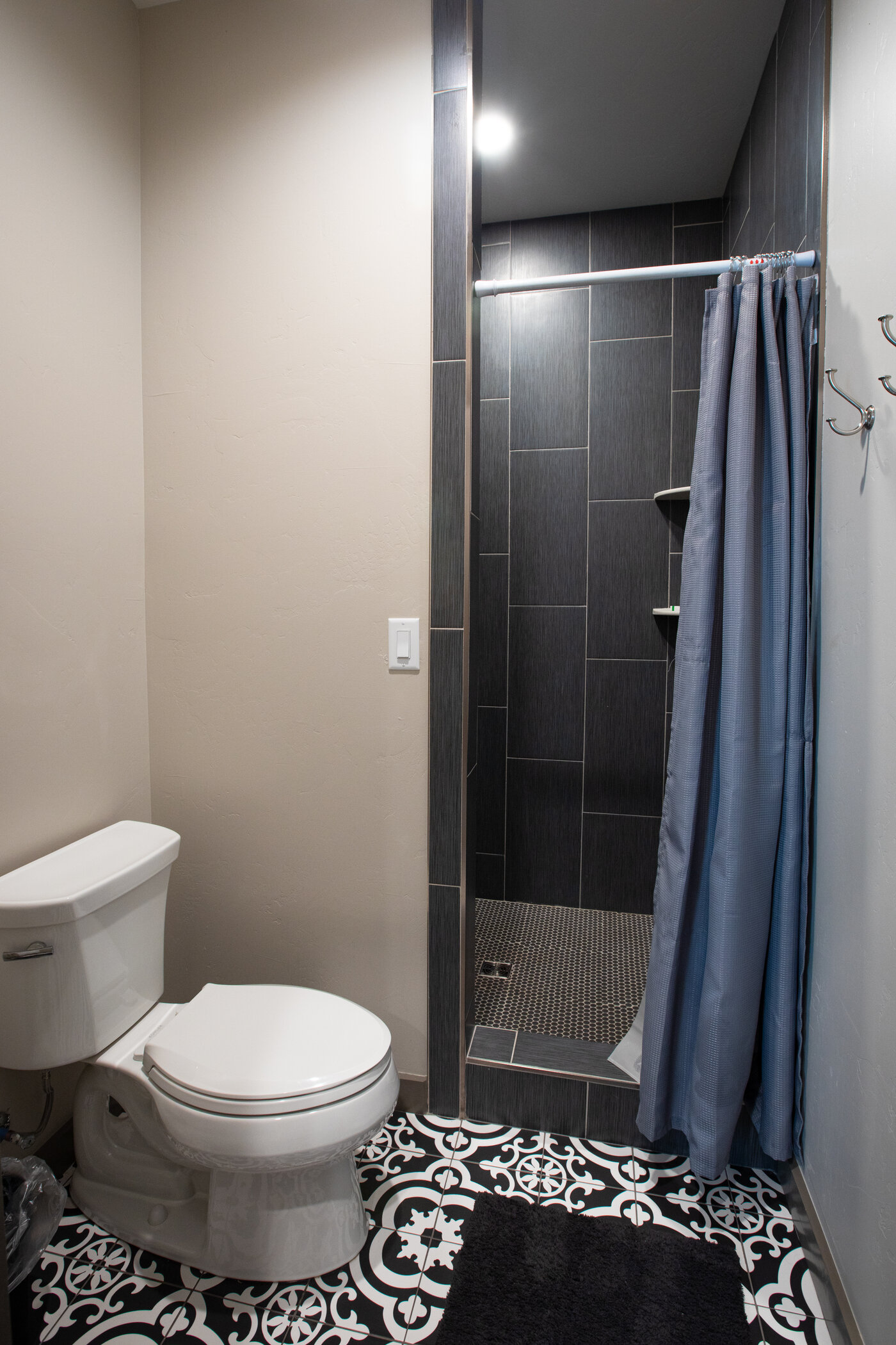 Teton View Retreat — Both Domes — secondary bathroom with charcoal tile shower and patterned cement floor