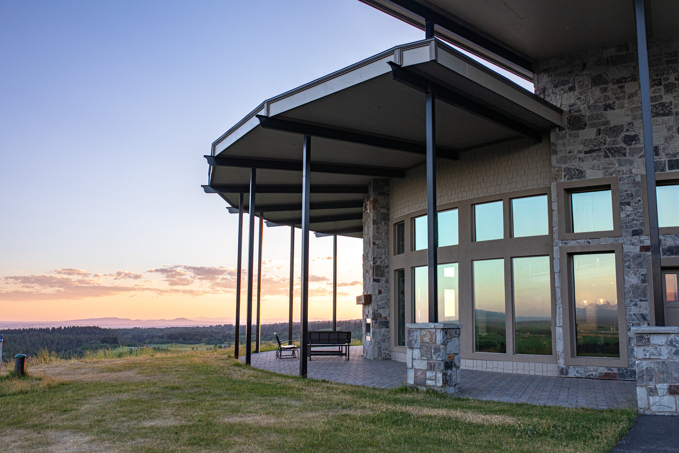 Teton View Retreat — Both Domes — cantilevered covered porch wrapping around the cabin at golden hour