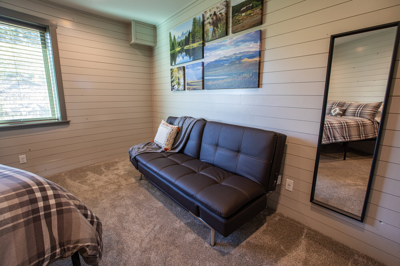 Teton View Retreat — Both Domes — bedroom with futon, queen bed, and Teton-range canvas art