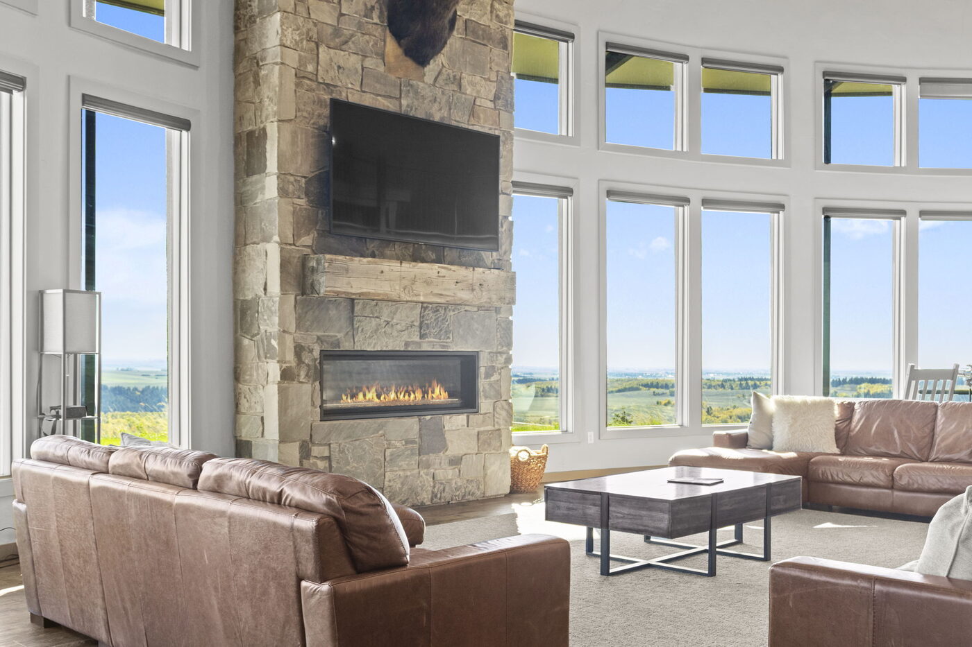 Teton View Retreat — Both Domes — great room two-story stone fireplace with windows facing the Tetons