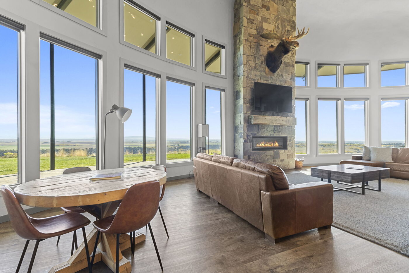 Teton View Retreat — Both Domes — great room with leather sofas, mounted moose, and panoramic windows