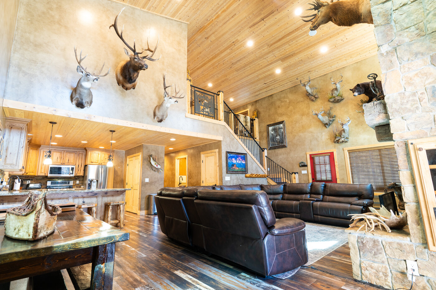 Trails End Lodge — great room cathedral with taxidermy gallery and stone fireplace
