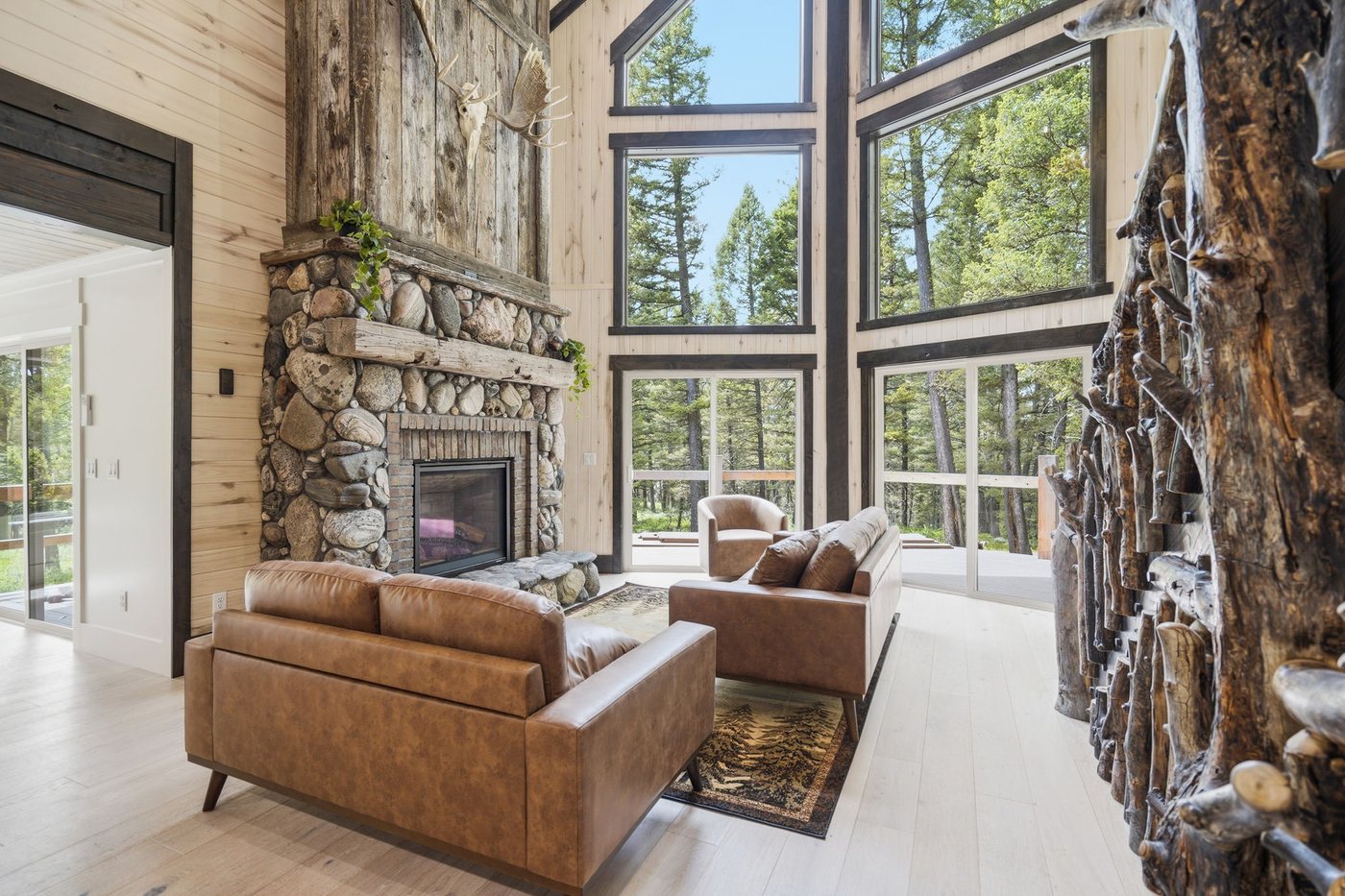 The Treehouse — living area with tree trunk column and stone hearth